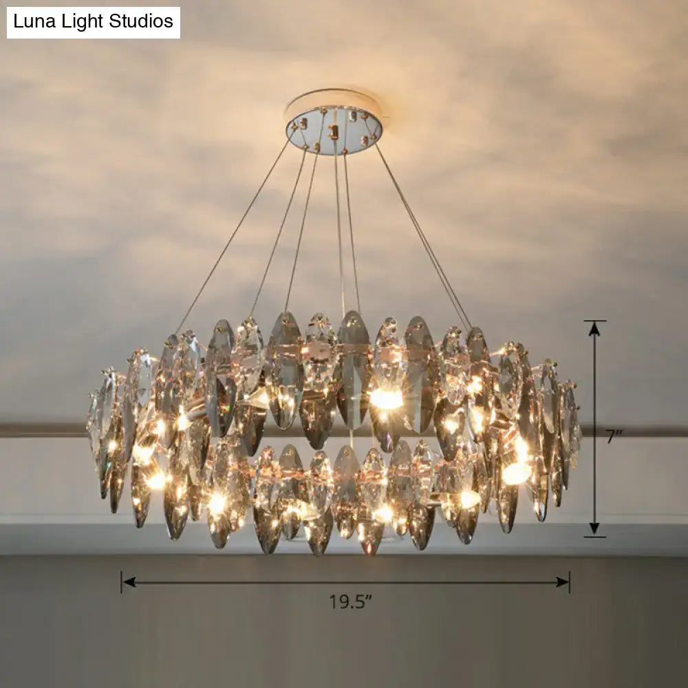 A two-tiered minimalist oval crystal clear pendant chandelier with faceted teardrop crystals and chrome mount for 220v-240v use