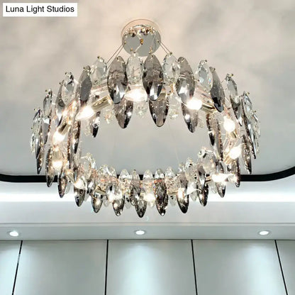 A two-tiered minimalist oval crystal clear pendant chandelier with faceted crystals and polished chrome frame for 220v-240v use