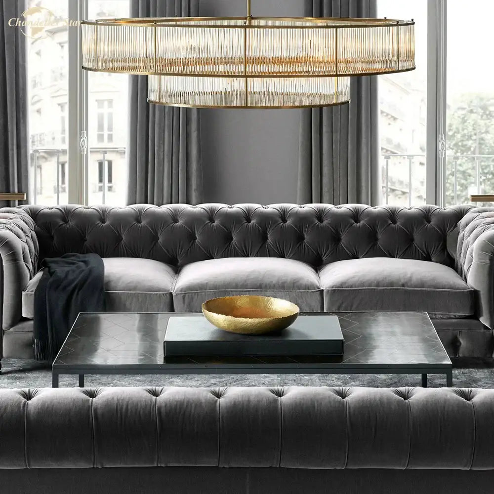 Dark gray tufted velvet sofa paired with modern chrome ribbed glass chandeliers from decorbites glass chandeliers collection