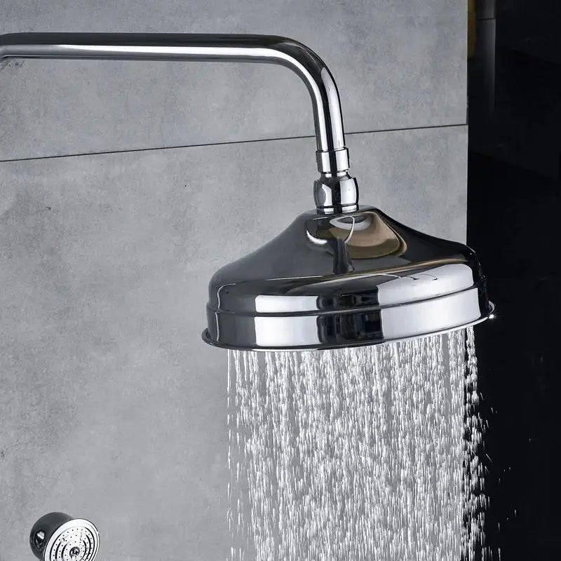 Modern chrome shower mixer faucet set with round chrome showerhead and visible water spray for bathroom use