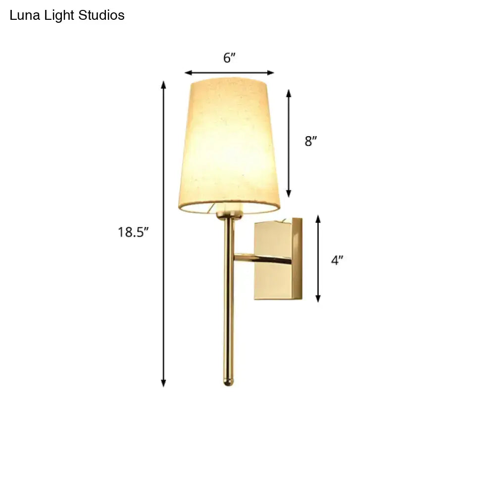Gold-finished tapered wall sconce with a warm beige fabric shade ideal for modern bedroom fabric led light lighting
