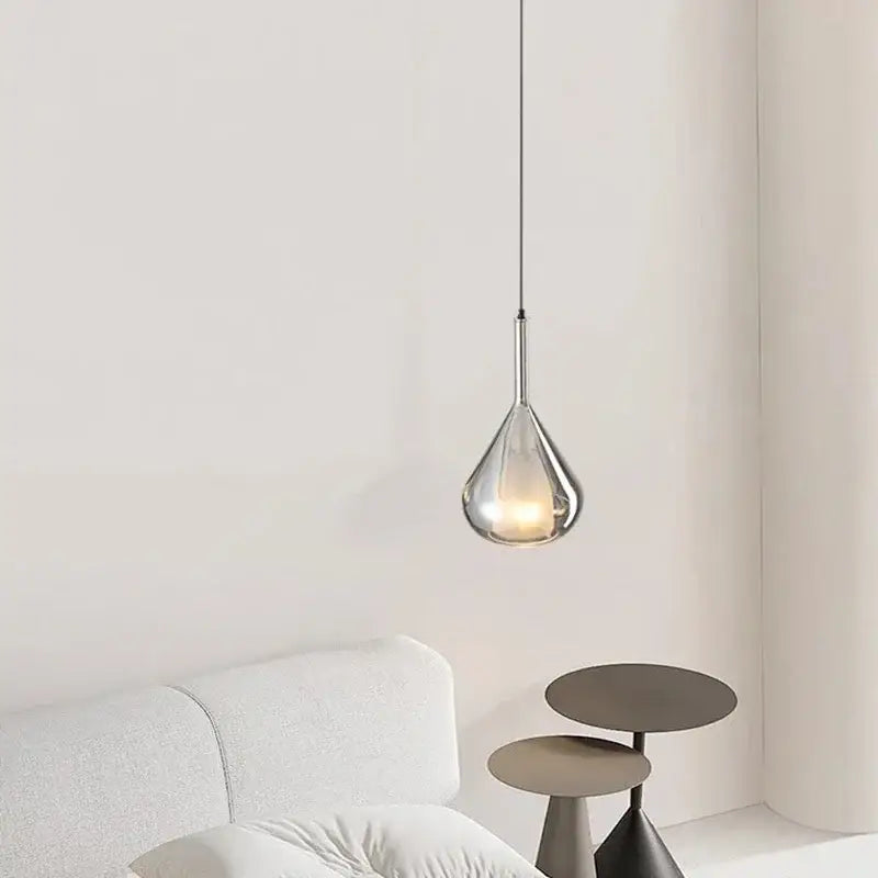 Modern chrome teardrop chandelier pendant light with translucent glass body and metallic finish for dining room