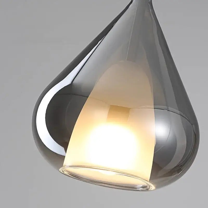 Modern chrome teardrop chandelier pendant light with glossy finish and warm bulb ideal for dining room pendant lights