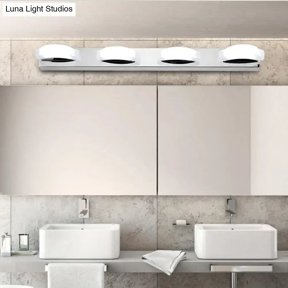 Modern chrome vanity mirror light with three circular white warm color diffusers and warm color temperature