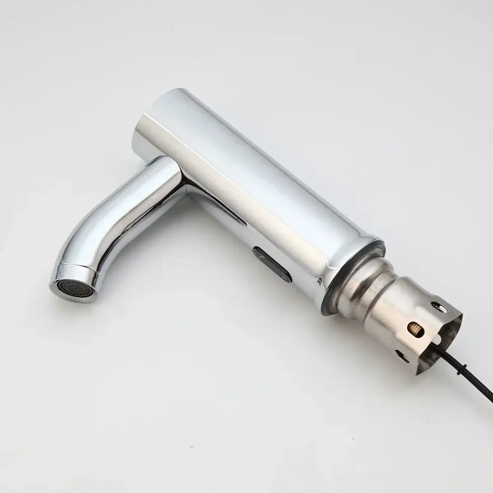 Modern chrome touch sensor basin faucet with sleek cylindrical design and visible wiring at the base for bathroom use
