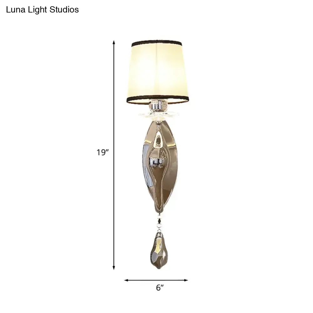 Elegant silver-toned living room wall lamp with fabric cream shade and crystal teardrop pendant for modern decor