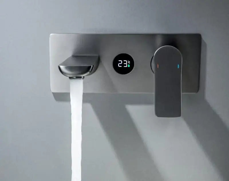 Modern chrome wall mounted basin faucet with brass valve core and digital temperature display showing 23°c