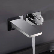 Modern chrome wall mounted basin faucet with sleek angular design, brass valve core, and circular handle with v-shaped indentation