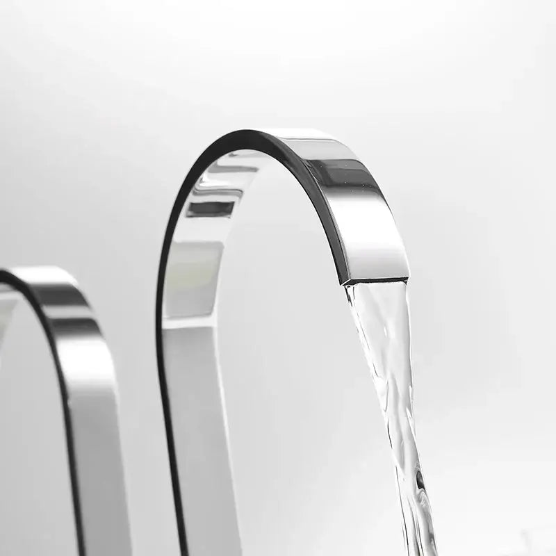 Modern chrome waterfall brass chrome bathroom sink faucet with sleek curved design and flowing water stream decorbites brass chrome bathroom sink decor