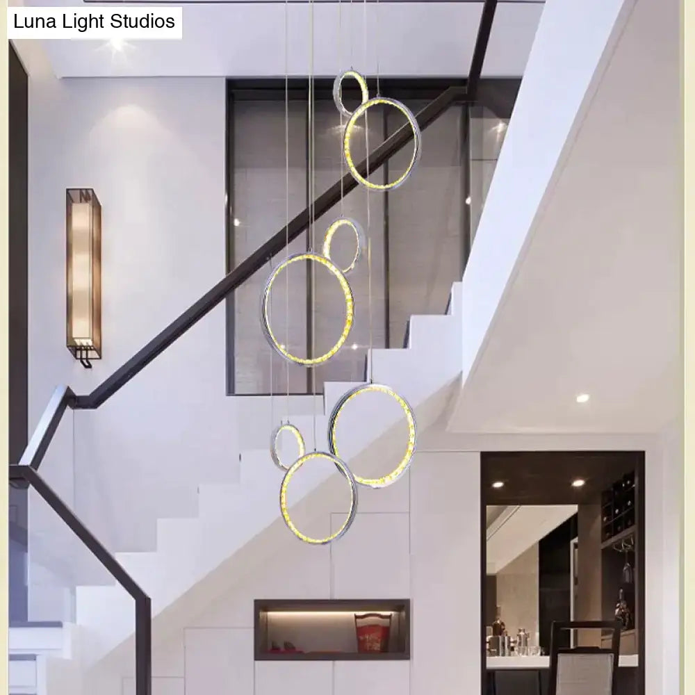 Modern DecorBites™ circle led crystal pendant lamp with interlocking rings and warm golden crystal light glow