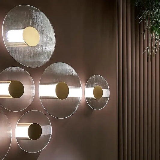 Modern circular brushed metallic wall lamp with warm-toned accents for elegant glass wall decorbites living room sconce