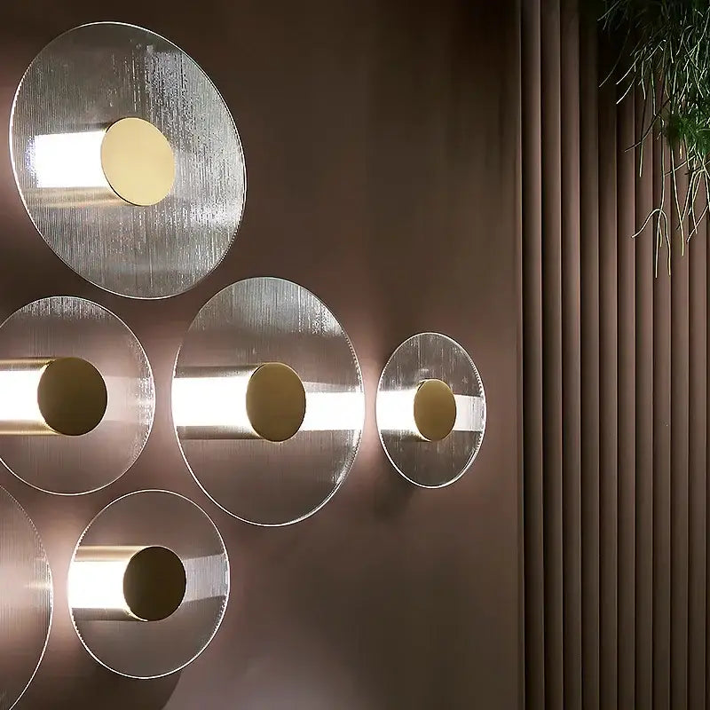 Modern circular brushed metallic wall lamp with warm-toned accents for elegant glass wall decorbites living room sconce