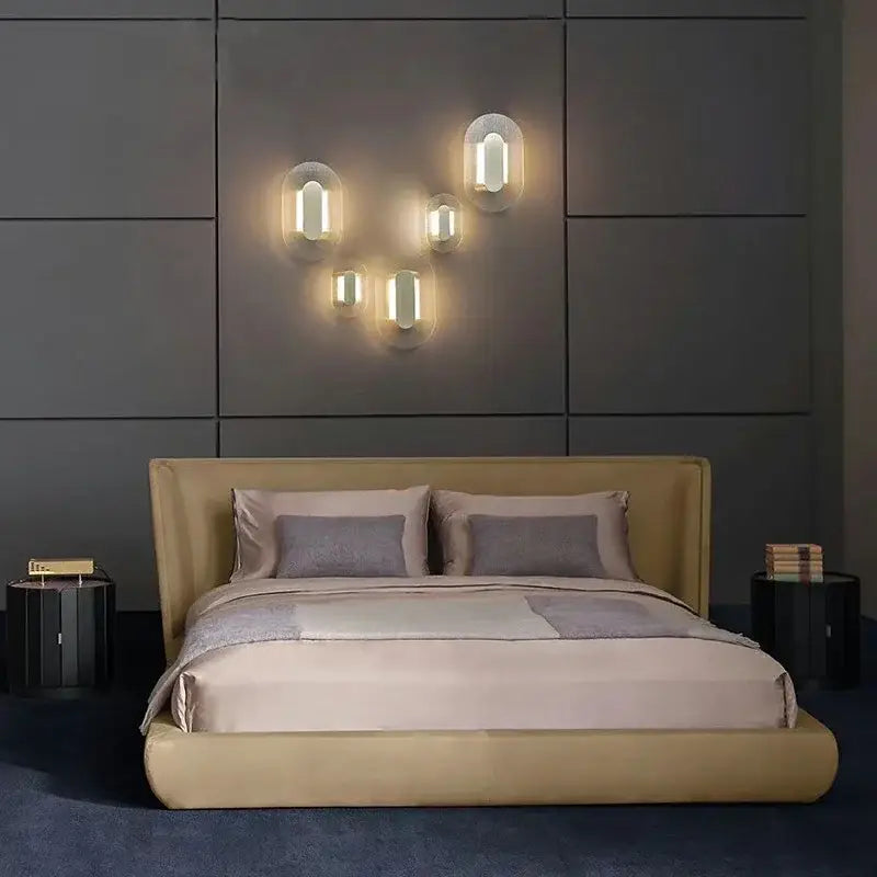 Modern circular brushed metallic wall lamp with warm glowing frosted glass shades for elegant glass wall décorbites decor