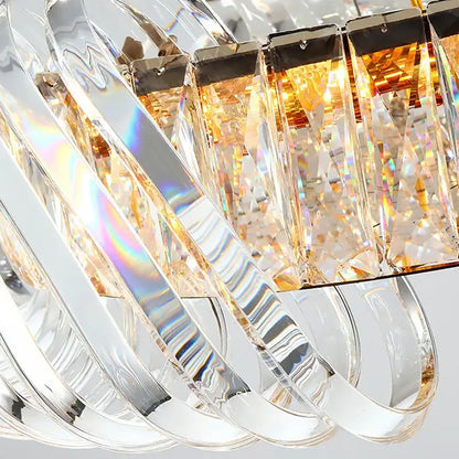 A modern circular crystal led ceiling chandelier with clear crystal prisms and warm amber lighting for dining room decorbites crystal led