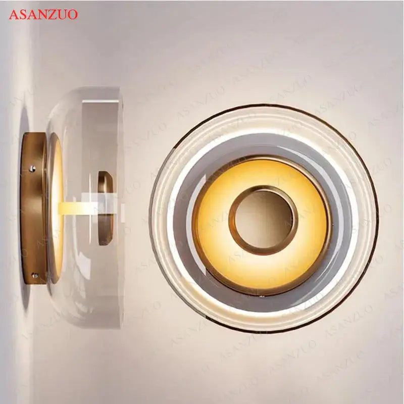 Modern circular gold-toned wall sconce with clear glass bowl led and concentric rings for bedroom decorbites decor
