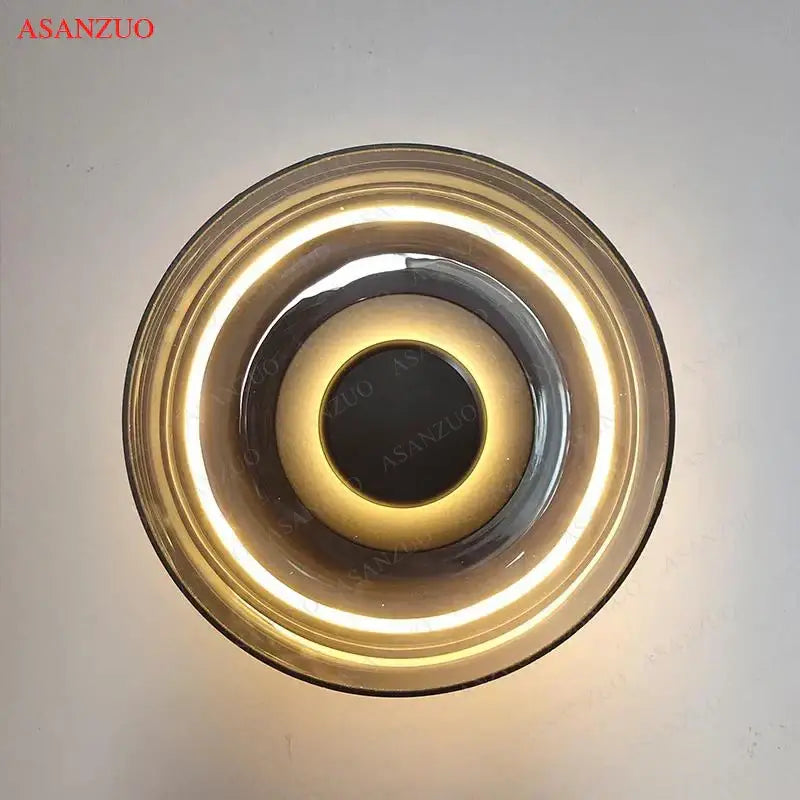 Gold-toned modern circular glass bowl led wall sconce with concentric rings and glowing led ring for bedroom decorbites decor