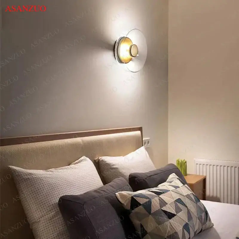 Modern circular glass bowl led wall sconce with warm golden light and metallic base for bedroom decorbites decor