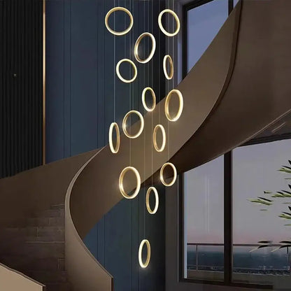 Golden circular decorbites led pendant lights hang in a modern minimalist arrangement for living room and staircase