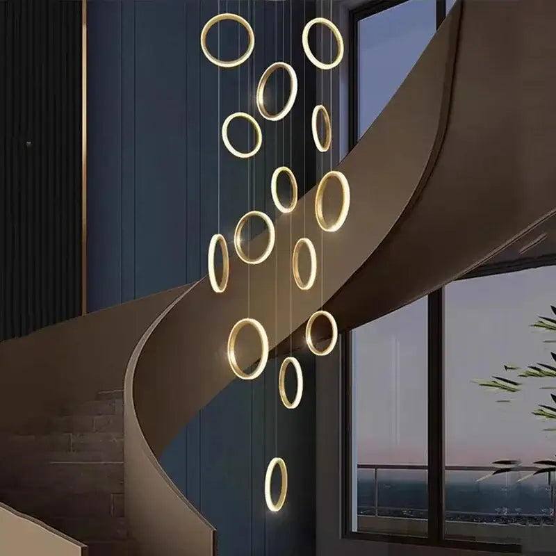 Golden circular decorbites led pendant lights hang in a modern minimalist arrangement for living room and staircase