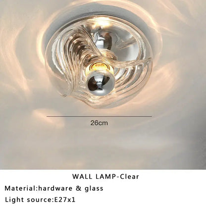 Modern circular swirling designer glass wall lamp with clear transparent glass and metallic hardware for bedroom decorbites designer glass wall