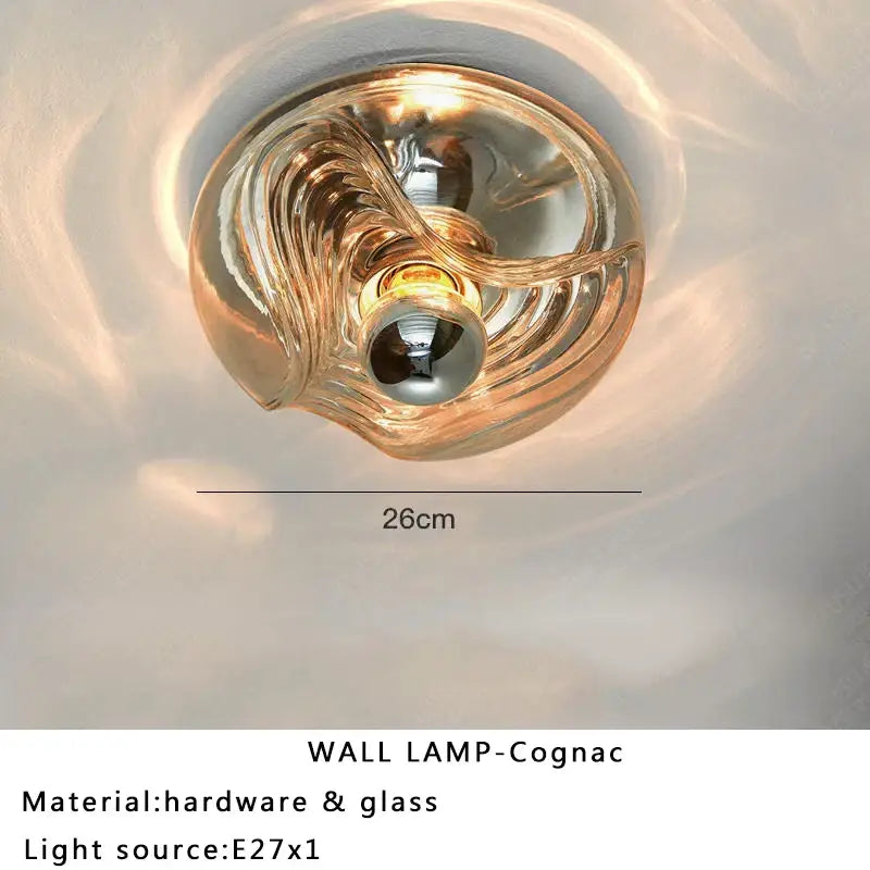 Modern circular swirling amber designer glass wall lamp with metallic hardware for bedroom decorbites designer glass wall