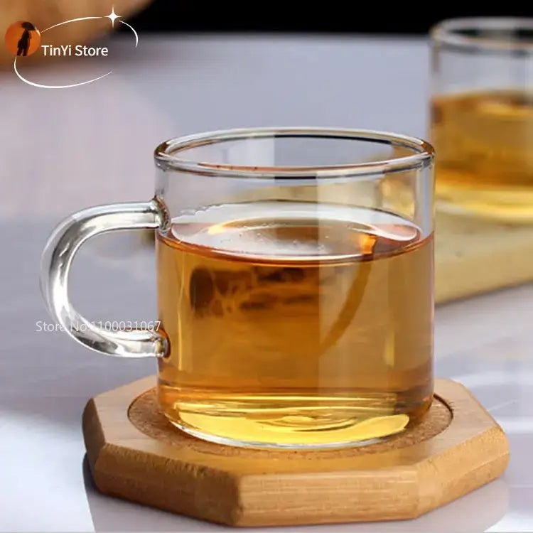 Modern clear 2pc 120ml glass handle coffee cup set with amber liquid in a clear glass mug with handle for dining room use