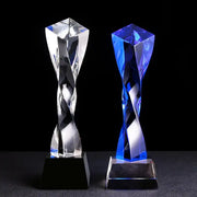 Two crystal award trophies featuring a modern clear and blue glass twisted column with faceted surfaces decorbites blue glass