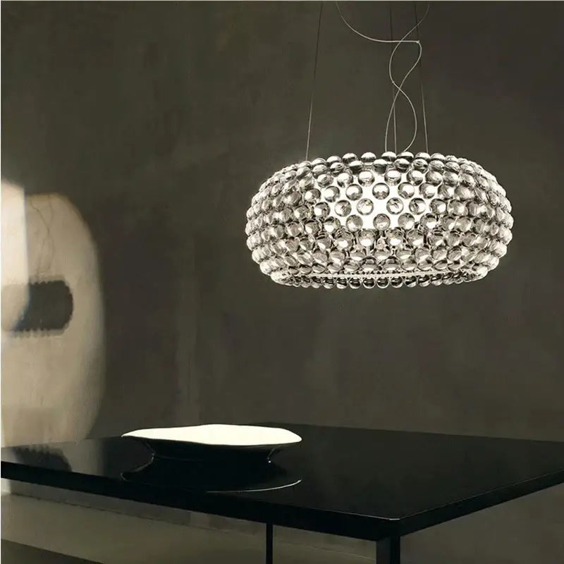 A modern clear bubble caboche led chandelier with numerous glass beads in a spherical pattern for living room