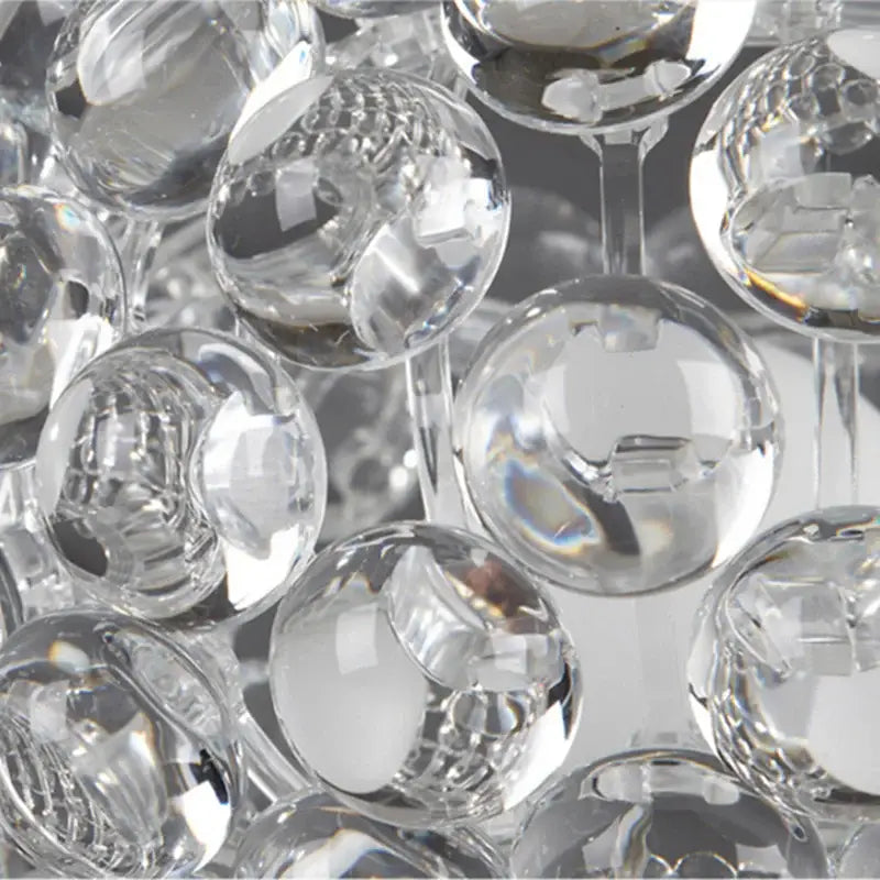 Modern clear bubble caboche led chandelier featuring faceted glass spheres with intricate cut patterns and reflective surfaces