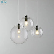 Modern clear bubble glass ball pendant light with black metal fixtures and exposed filament bulbs for kitchen decorbites pendant light