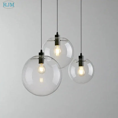 Modern clear bubble glass ball pendant light with black metal fixtures and exposed filament bulbs for kitchen decorbites pendant light
