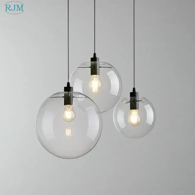 Modern clear bubble glass ball pendant light with black metal fixtures and exposed filament bulbs for kitchen decorbites pendant light