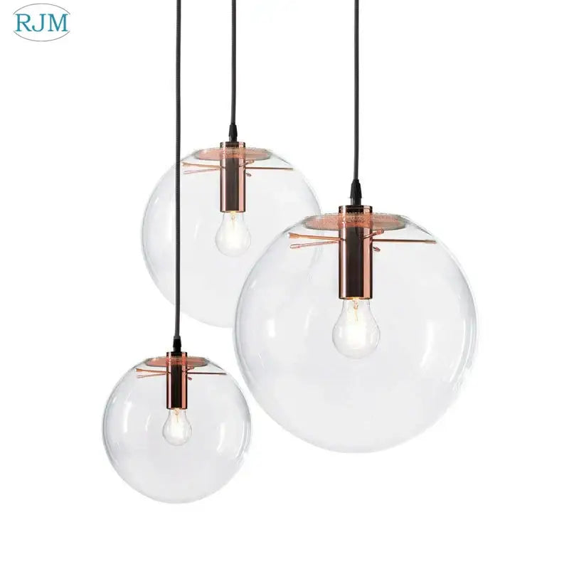 Set of three clear glass bubble glass ball pendant lights with copper-toned metal fixtures for modern decorbites pendant light decor