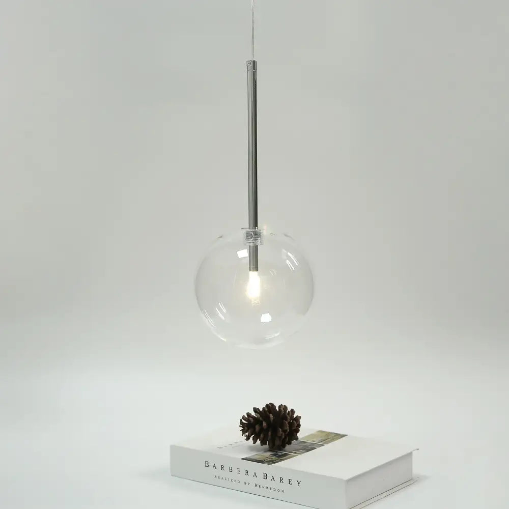 Modern clear bubble glass pendant light with bubble glass ball and black metal fixtures for kitchen decorbites design