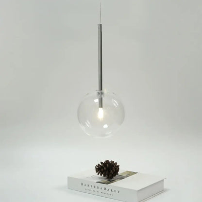 Modern clear bubble glass pendant light with bubble glass ball and black metal fixtures for kitchen decorbites design