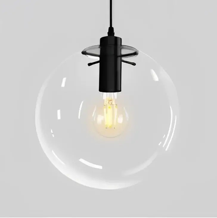 Modern clear bubble glass ball pendant light with a black metal fixture and exposed filament bulb for kitchen decorbites