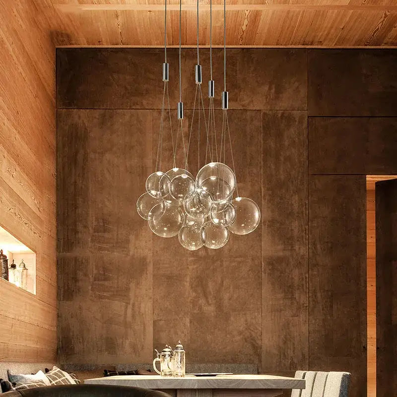 Modern clear bubble glass pendant light with clear spherical bulbs and sleek metallic rods for dining room decorbites bubble glass
