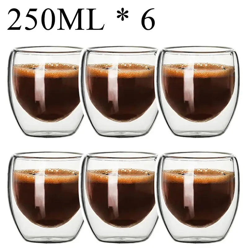 Set of six clear double wall borosillicate glass espresso cups filled with dark espresso and crema layer