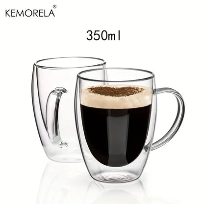 Modern clear double wall glass coffee mug with handle holding dark espresso topped with creamy foam for kitchen use