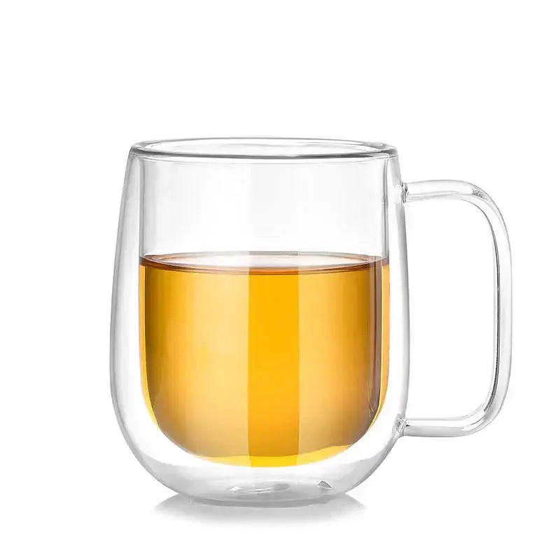 Modern clear double wall glass mug with handle filled with amber liquid for kitchen tea use