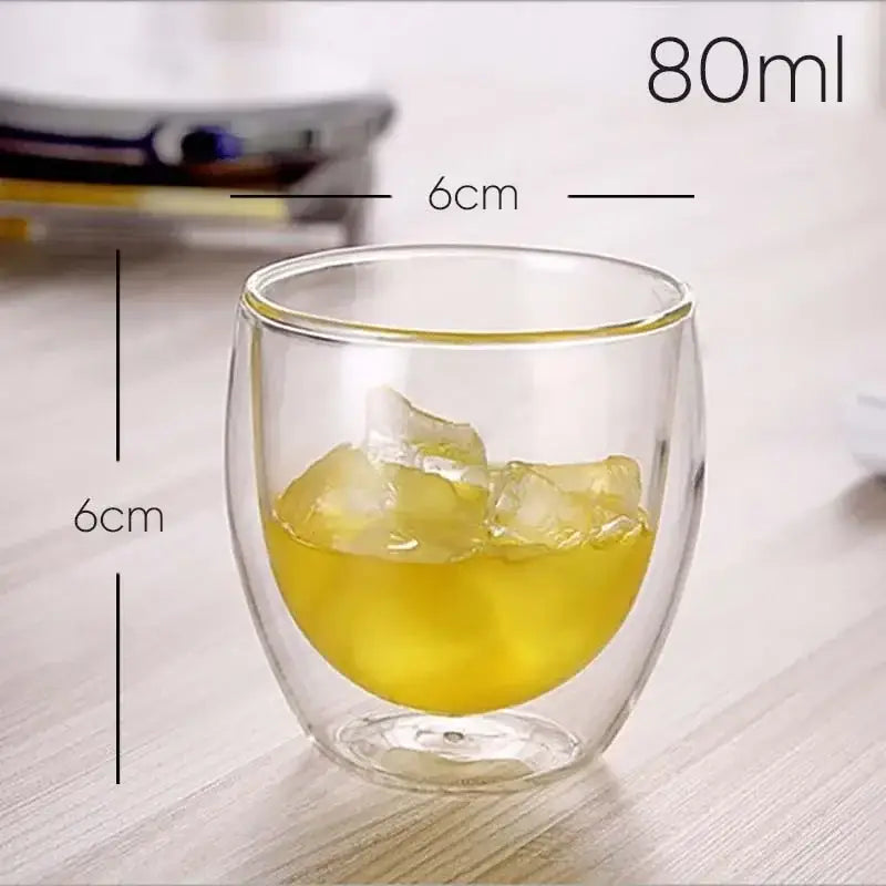 Modern clear double wall glasses tumbler 80ml filled with golden-yellow liquid and ice cubes for kitchen use