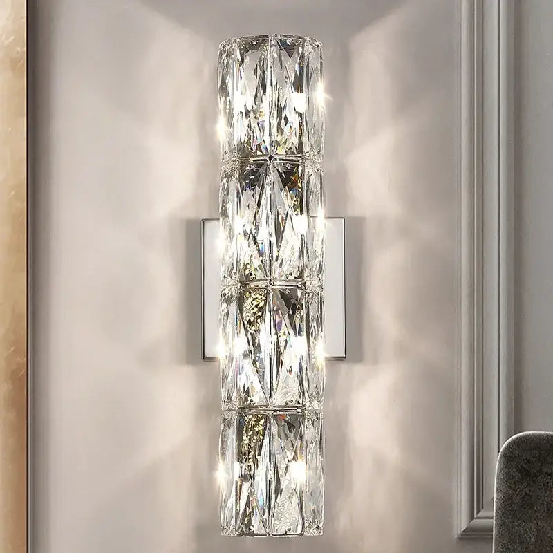 A modern clear faceted decorbites crystal wall lamp with silver metal backplate for luxury living room decorbites crystal high-end