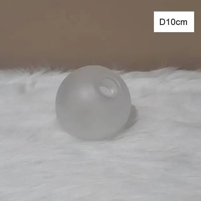A frosted glass globe shade cover replacement with smooth translucent surface for modern living room lighting