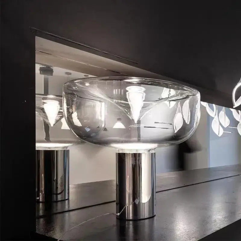 Modern clear glass aella table lamp with a sleek chrome base ideal for bedroom and office decorbites aella table
