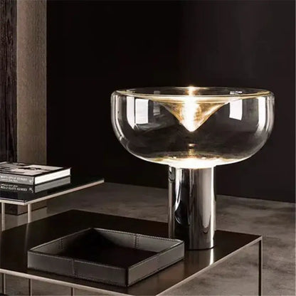 Modern clear glass aella table lamp with sleek chrome base and transparent bowl shade for bedroom office decorbites aella
