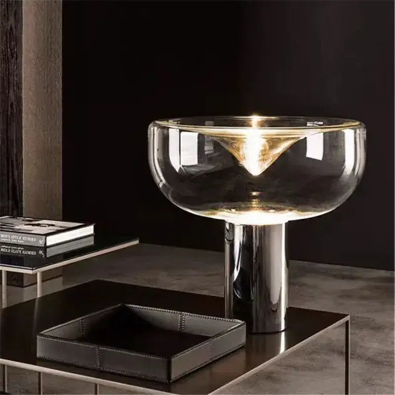Modern clear glass aella table lamp with sleek chrome base and transparent bowl shade for bedroom office decorbites aella