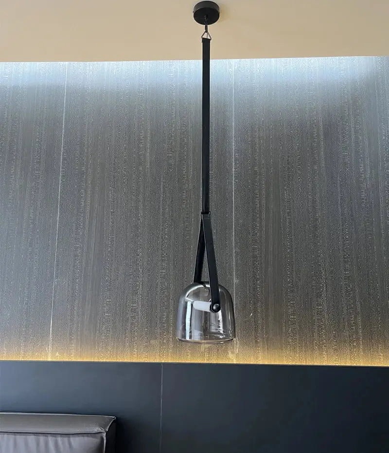 Modern clear glass and black leather pendant light fixture with bell-shaped shade for kitchen lighting