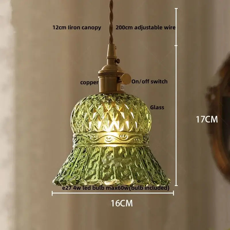 Modern clear glass copper pendant light featuring a green glass pendant light with intricate cut patterns and brass fixture