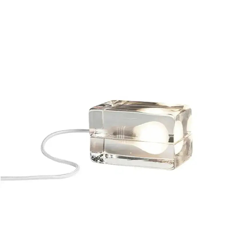 Modern clear glass cube led table lamp with visible bulb and white cord for bedroom nightlight use