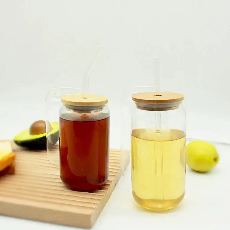 Modern clear glass cups with bamboo lids and transparent straws filled with amber and golden liquids decorbites glass cup